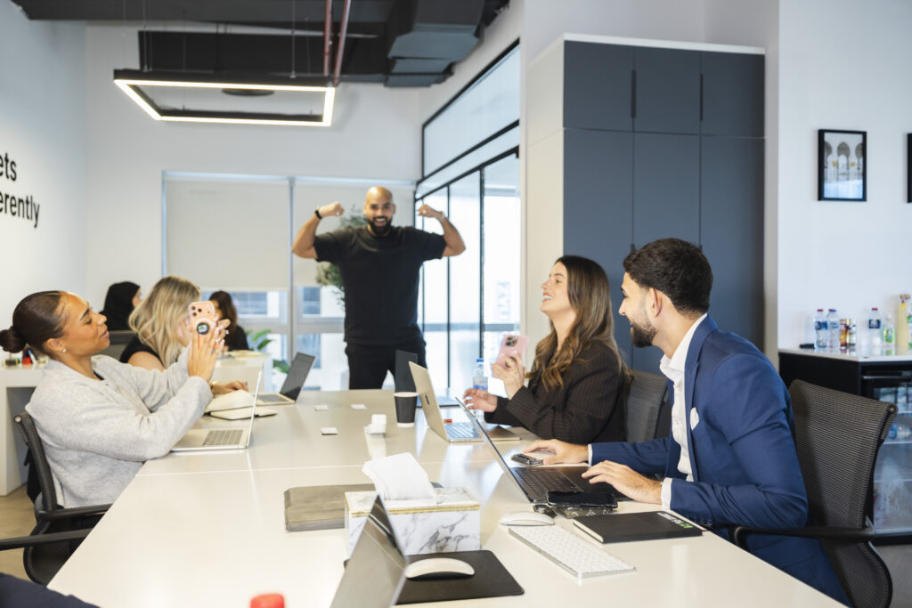 team photo of 1416 real estate agents along with the CEO in their office in Dubai